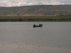 Three hours later, vainly trying to catch some fish on the lake Kokuikul, we have got a pity thoughts about our luck these days. I haven't got any bites these days, Asat and Ruslan caught one small crucian (finger size) and that's all. Loking at them in the boat I thought they began to sleep already. We should change this routine. Shouted a few minutes to each other about our plans and results we decided to move to other place - to issyk-Kul Lake.