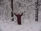 All trees and branches were covered with snow. And some branches were not strong enough to keep it.
At the photo: Lyuba among the branches and trees covered with snow.