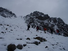 After the rest and waiting for the clear weatehr around we could see "our" pass. There - in between two rocks - is the pass Terimtor 4000m - our last point for today. Usually I didn't see so much snow in this time (there was a small 'tongue' just before the passage last years) of the year, but we had it everywere from a lower altitude now.
We organized a chain and, changing the leading man, moved up.