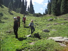 The trail in the frest is going sometimes deep down. So we were moving carefully and slowly. At photo: Alina, Lyuba, Janyl and Azat