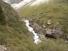 The trail to Ala-Kul Lake is going to the right. This lake is very popular to visit for tourists. The altitude of it is 3532 m above the sea level. The color of water is changing depending on the current weather. The depth of this lake is unknown, at least I didn't hear about it.
Our way is going to the left and up to the snow from this point.