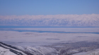 Такой вид зимнего озера Иссык-Куль, замерзшего города Каракол и противоположных гор массива Кюнгей Ала-Тоо открывается с высоты 2750м, где заканивается кресельный подъемник горнолыжной базы Каракол.