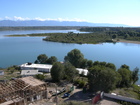 View of part of Djergalan bay of Issyk-Kul Lake. Possible to see Karakol river mouth, popular beach of Karakol citizens, far away it's possible to see Mikhailovka dachas.