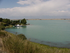 This is a view of so-called 'city beach'. The part of Issyk-Kul (small creek) that is using for summer visiting by the most of people of Karakol town. The left part of the creek - not used often for swimming.