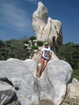 Lyuba is sitting in comfortable stone in the park not far from Pattaya