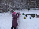 The snow was good enought to sculpture a snowman. And Lyuba, with the help of Zhanna, created one snowman using an ashberry for the eyes and twigs for the ears and mouth.