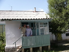 Me and grandfather are standing on front steps of his house.