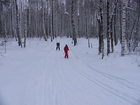 Zhanna and Dmitry ski down from the hill after Lyuba.