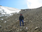 Alina and snow carnice of Ala-Kul pass behind. We went over the pass and going down seemed to be a little bit easier than climbing. But this deep scree was also dangerous, so our speed was not too quick. And of course we all were tired.